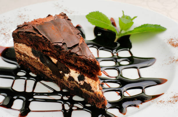 istock chocolate cake with a brown topping and sprig of mint 1208116573
