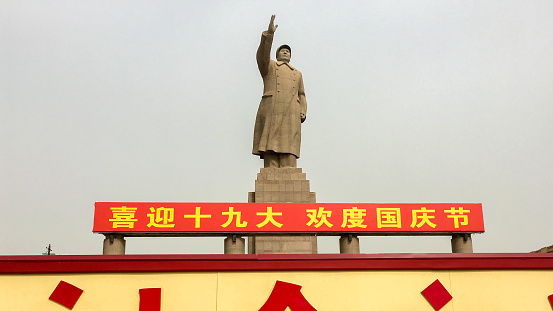 KASHGAR, XINJIANG / China - October 4, 2017: Statue of Mao Zedong at the People's Square of Kashgar. The chinese characters below read \