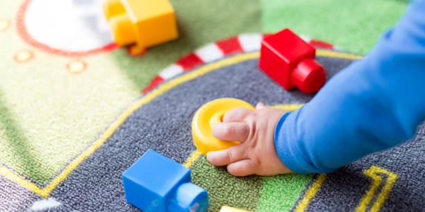 istock Cute one year old baby playing 1208121229
