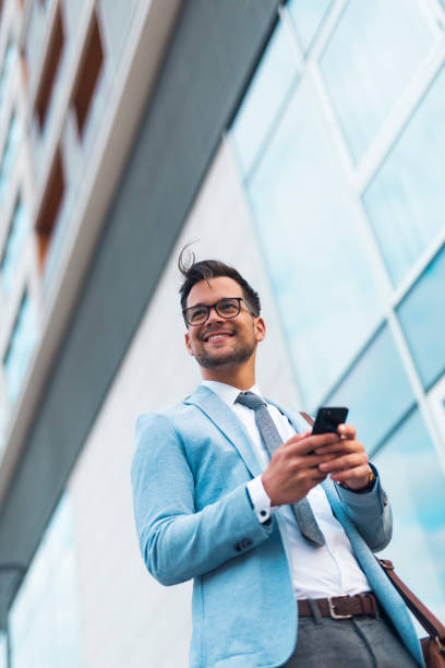 istock Businessman in suit holding phone. 1208124427