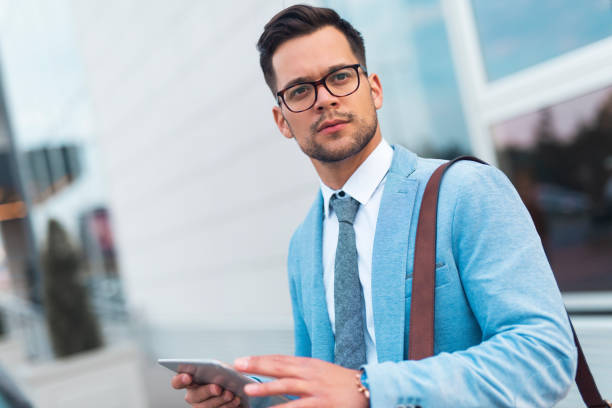 istock Young businessman holding tablet. 1208124443
