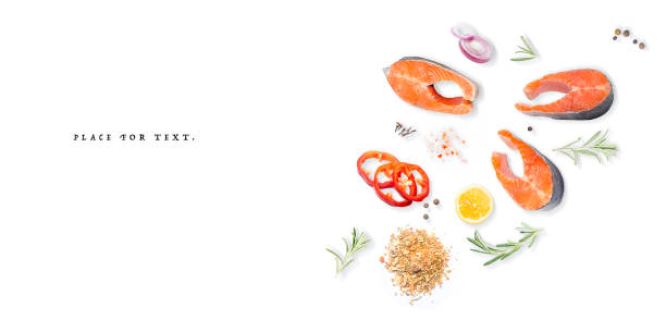 Salmon steak with lemon, rosemary and pepper on a white background