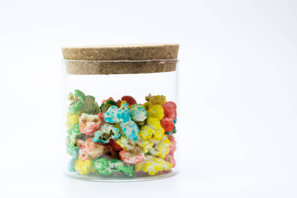 istock Glass jar of colored popcorn with white background 1208129031