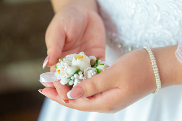 istock Bride's hands with a bouquet for the groom. place for text 1208129132