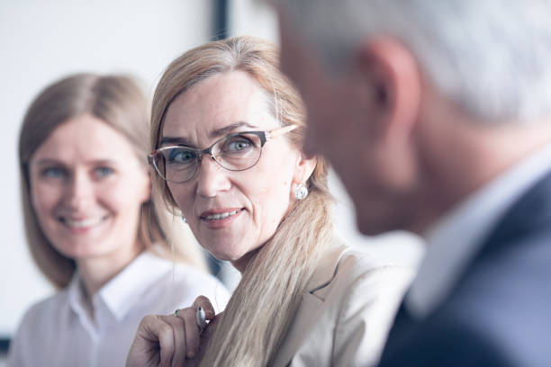 istock Business people sitting in a row 1208131723