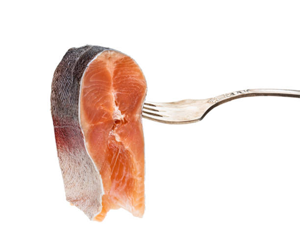 istock Salted slice of rainbow trout on a fork isolated on white 1208131927