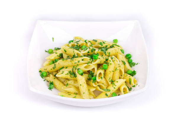 Pasta with parsley and green peas. Isolated in a white background. Close-up.