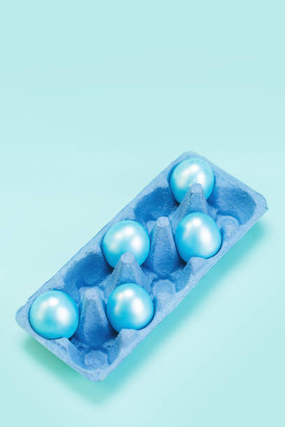istock Modern trendy easter concept with pearl blue colored eggs in cardboard market blue tray 1208137807