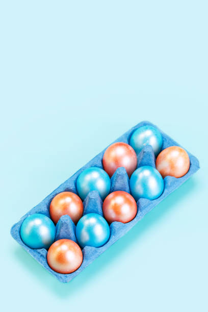 istock Modern trendy easter concept with colored eggs in cardboard market blue tray 1208138088