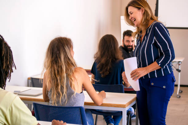 istock Group of students and a teacher in a classroom. 1208138834