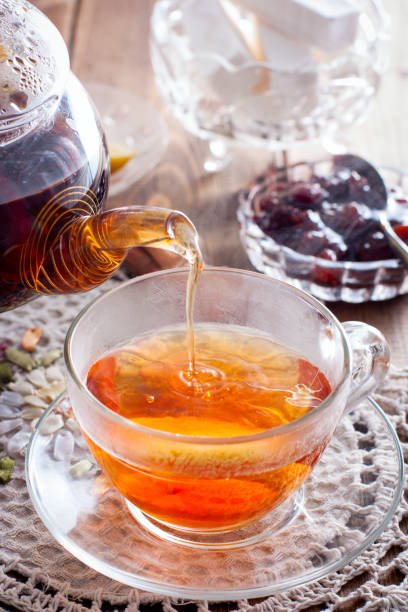 istock Black tea with cinnamon and lemon in a glass cup on a wooden table, selective focus 1208139812