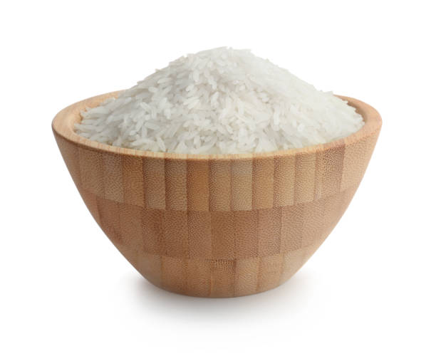 istock Rice in a wooden bowl isolated on white 1208141153