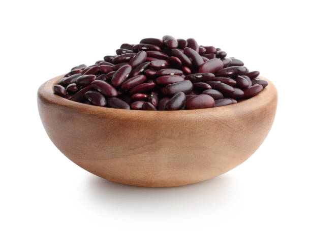 Red beans in a wooden bowl isolated on white background.
