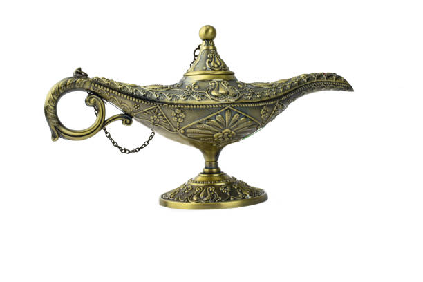 golden colored antique oil lamp with rust displayed over an isolated white background - arabian nights imagens e fotografias de stock