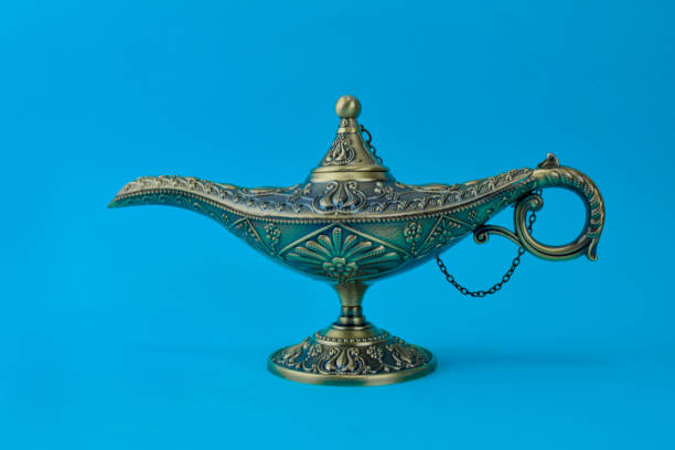 istock Antique golden colored oil lamp with rust displayed over an isolated blue background 1208143063