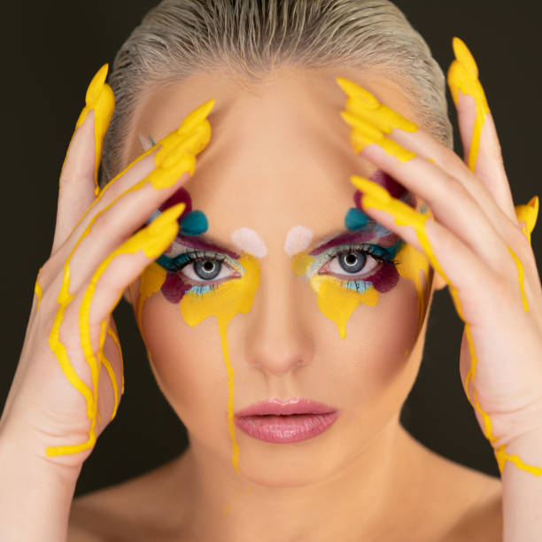istock Beautiful woman with colorful make-up 1208143619
