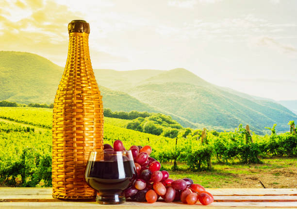 Brandy in a bottle on a vineyard background