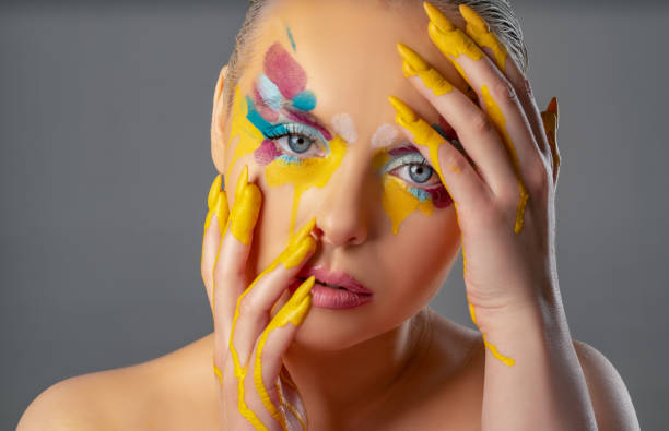 istock Beautiful woman with colorful make-up 1208144302
