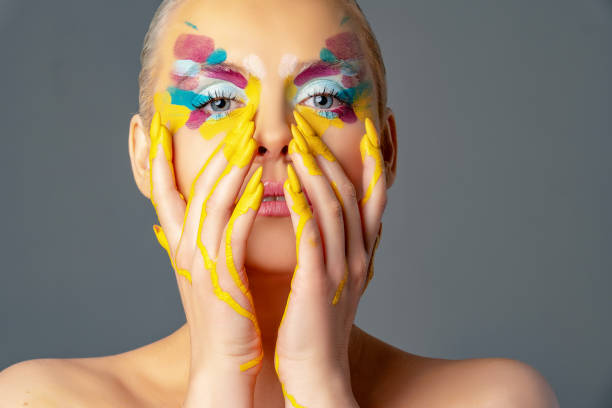 istock Beautiful woman with colorful make-up 1208144363
