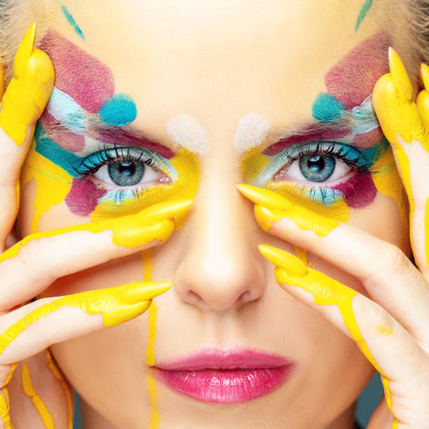 istock Beautiful woman with colorful make-up 1208144403