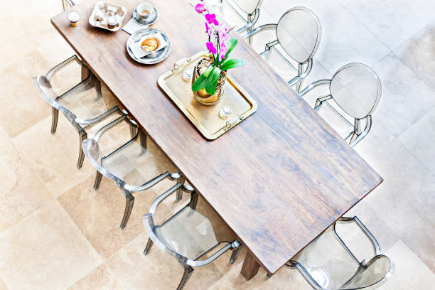istock Wooden dining table above view with plastic chairs 1208144831