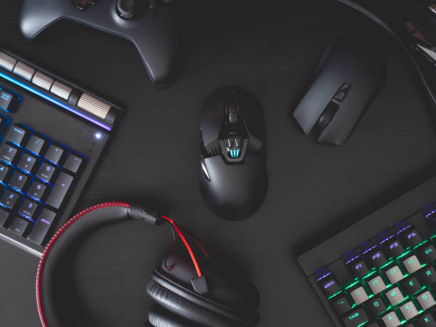 istock gamer work space concept, top view a gaming gear, mouse, keyboard, joystick, headset, mobile joystick, in ear headphone and mouse pad on black table background. 1208144842