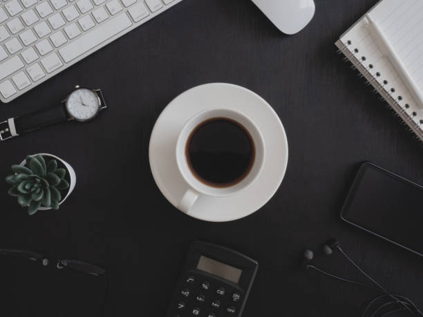 istock top view of office desk table with coffee cup and notebook on white background, graphic designer, Creative Designer concept. 1208144865