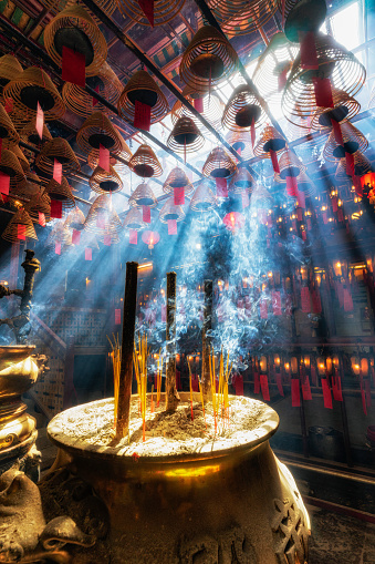 Man Mo Temple in Hong Kong island with sun beams and incense