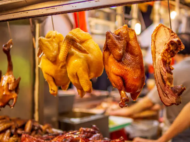 Cooked chicken, duck and pork are displayed in a showcase to attract customers at the local food market in Hong Kong.