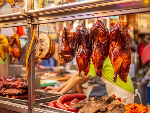 Cooked chicken, duck and pork are displayed in a showcase to attract customers at the local food market in Hong Kong.