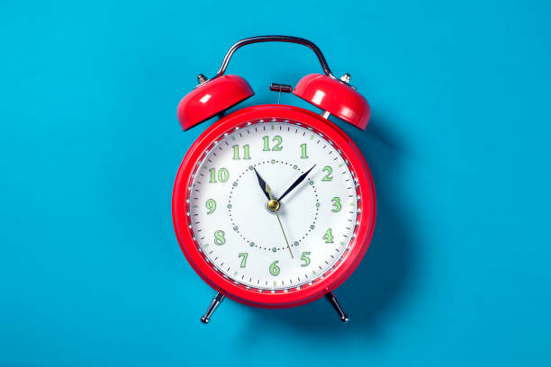 istock Alarm clock on the color background. 1208148269