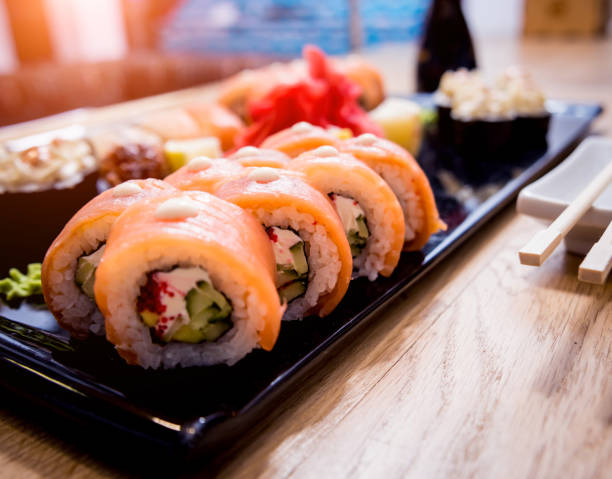 istock Sushi set. Rolls with salmon, eel and red caviar on a wooden plate. Restaurant. 1208149798