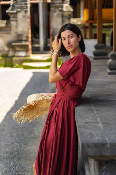 istock Pleased brunette girl leaning on stone support 1208150202