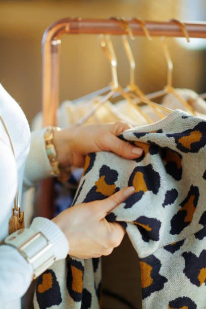 istock Closeup on young woman checking sweater for damage 1208151399