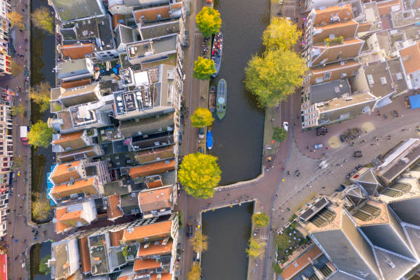 drone arrial view of  of prinsengracht canal the famous spot with old tradition house and church in amsterdam, the netherlands - zaanse schans bridge house water imagens e fotografias de stock