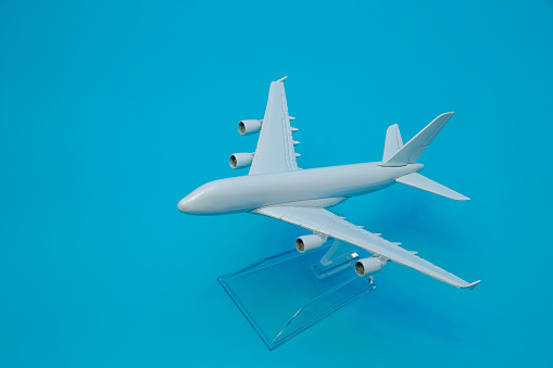 Miniature airplane on blue background