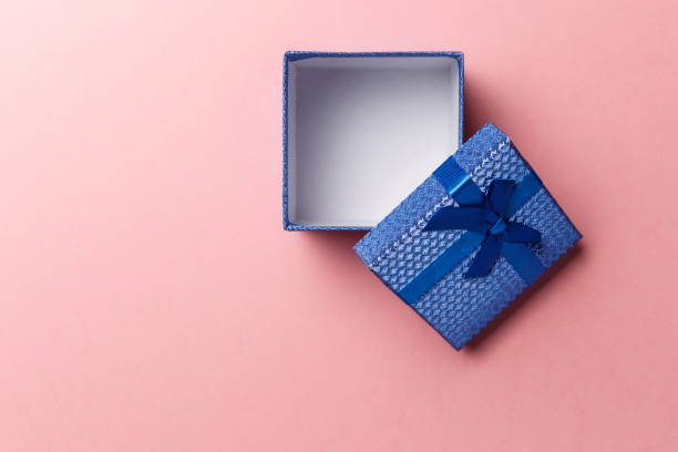 istock Blue empty gift box with blue ribbon on pink background. Top view. Flat lay. Copy space. Colorful background. Minimal christmas new year creative concept. Trendy pastel color 1208152680