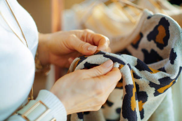 istock Closeup on trendy woman checking sweater for damage 1208152881