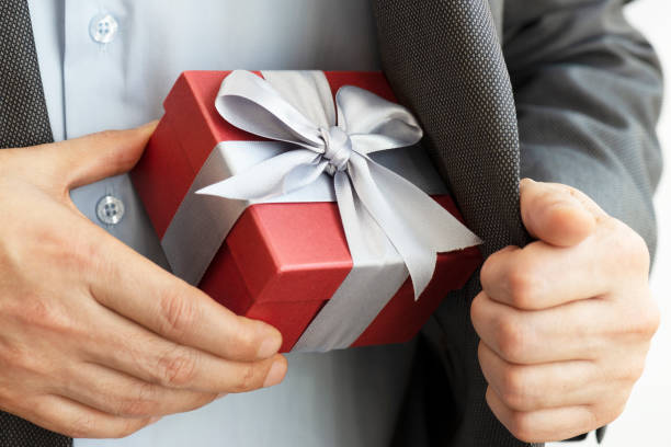 istock Businessman giving Gift Box 1208154198
