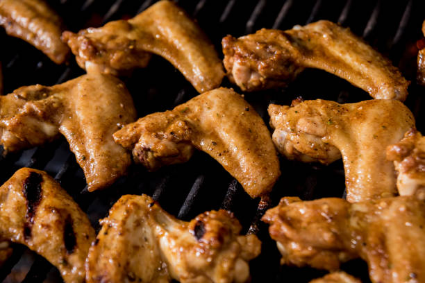 istock Fried chiken wings at barbecue grill. Restaurant. 1208154563