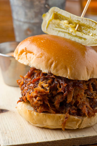 istock Pulled Pork Sandwich,  Barbecue meat sandwiches.  Brisket, beef ribs, pork ribs, bbq chicken or turkey served on traditional white hamburger buns. Traditional classic Texas style bbq. 1208157694