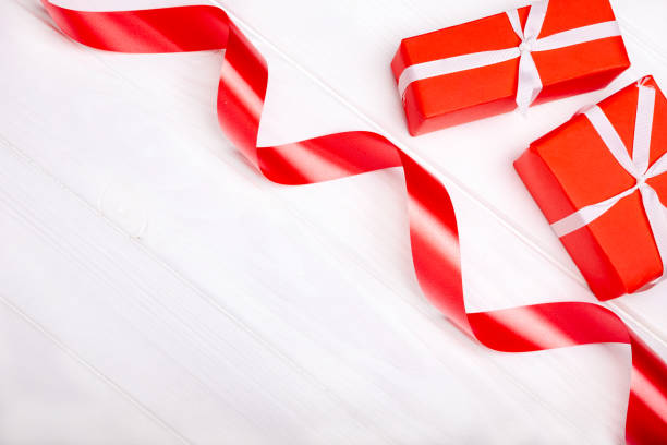 istock Red ribbon and box isolated on white background 1208157747