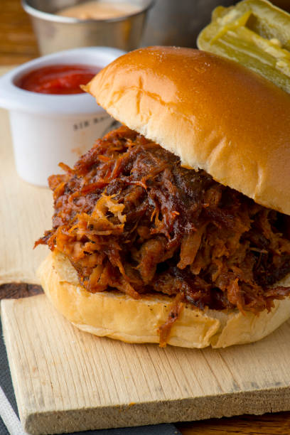 istock Pulled Pork Sandwich,  Barbecue meat sandwiches.  Brisket, beef ribs, pork ribs, bbq chicken or turkey served on traditional white hamburger buns. Traditional classic Texas style bbq. 1208157759