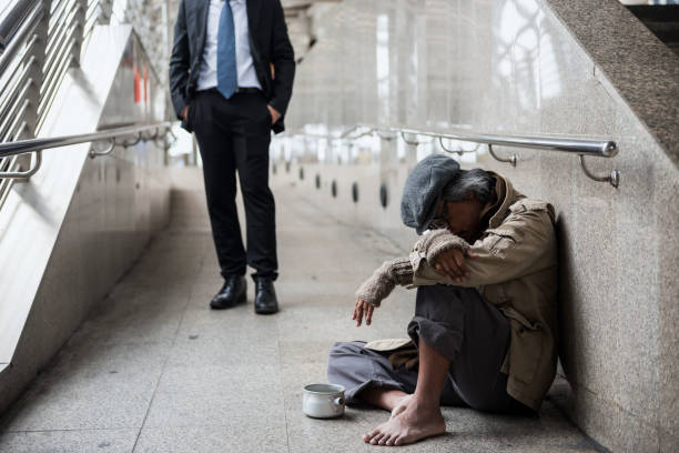 istock Old homeless man and kind businessman 1208158444