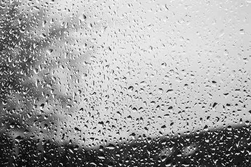 Beautiful abstract raindrop pattern on a window. Black and White image.