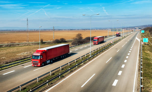 istock Three Red Trucks in line on a rural countryside highway 1208160385