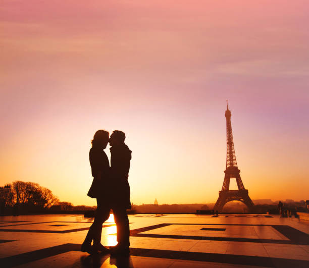 couple kissing near eiffel tower in paris, honeymoon in france - paris france eiffel tower love kissing imagens e fotografias de stock