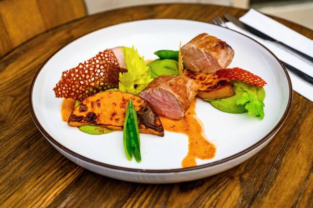 istock Pork tenderloin, baked pumpkin, pea puree, beet chips on plate. 1208166756