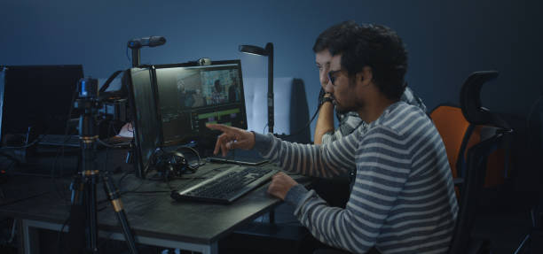 istock Film editors discussing a movie scene 1208167297