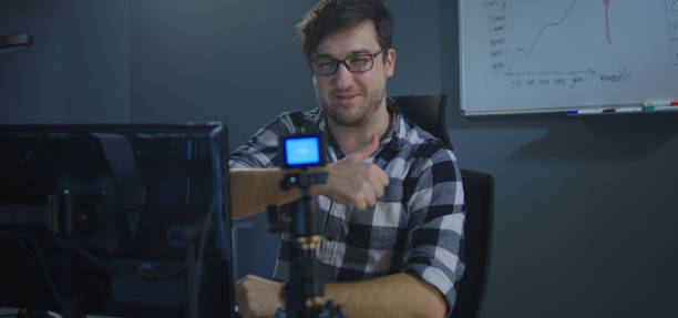 istock Man recording a vlog in office 1208167329